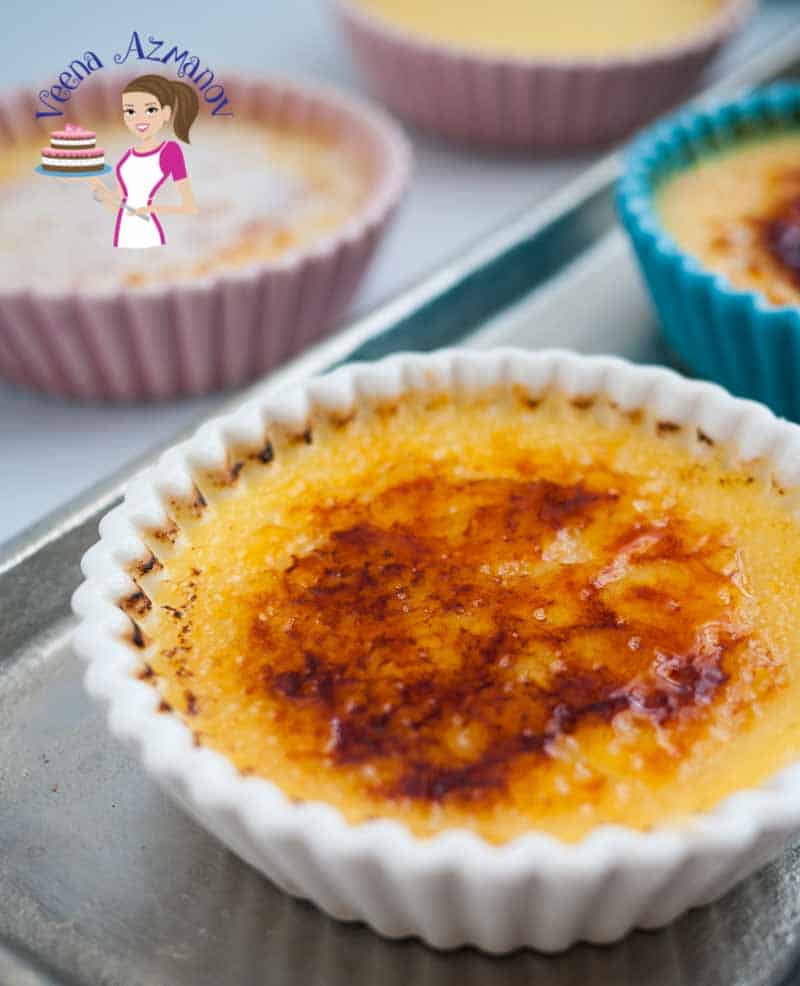 A small twist and you've turned your favorite classic creme brulee into this fruity summer Apricot Creme Brulee. This French dessert is a custard based dessert baked in a water bath then dressed in a glass-like caramel that scatters into the creaminess when eating. The sweet custard mixed with the slight bitterness from the caramel is truly exotic and indulgent. Apricot Creme Brulee - A Pinterest Optimized image for Apricot Creme Brûlée - a twist on the classic Creme Brûlée recipe featuring a close up of the individual serving of creamy custard some with the caramel glass.