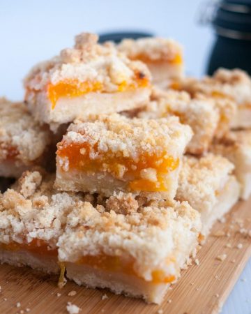 Apricot crumble bars on a wooden board.