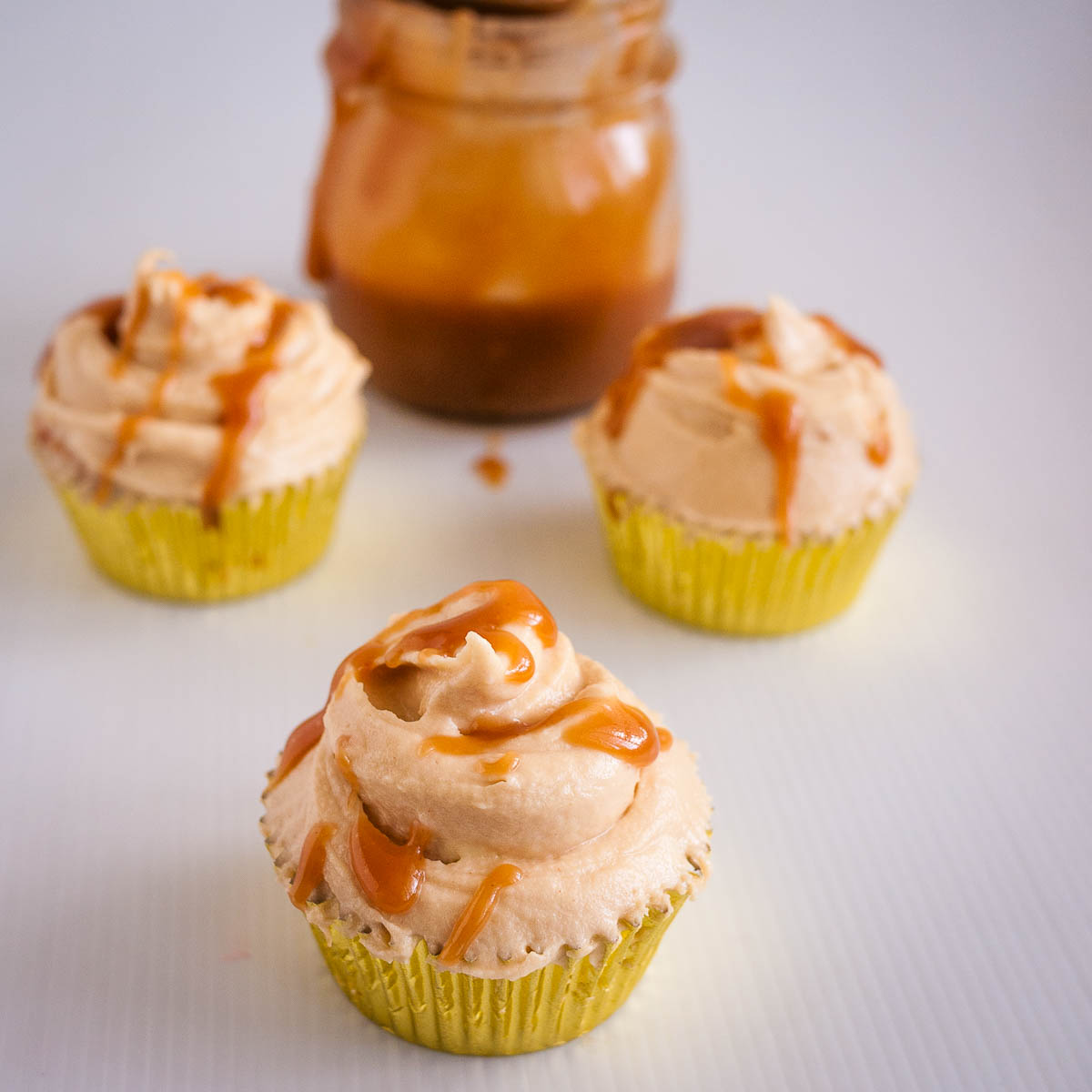 Cupcakes with butterscotch drizzle on top.