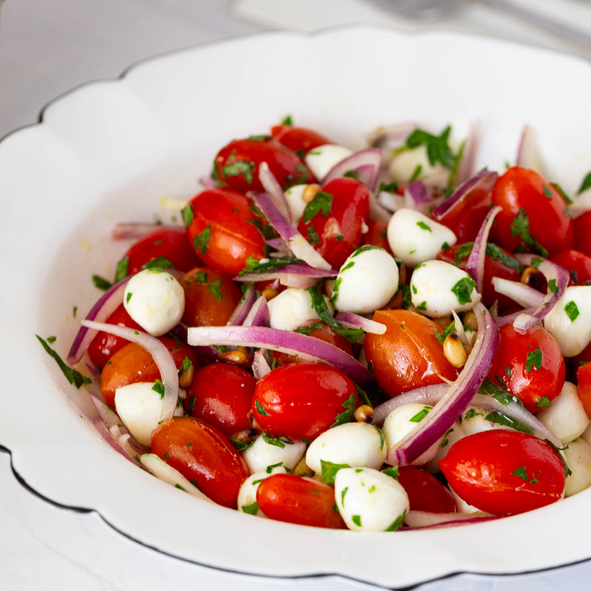 Tomato salad with Mozzarella in a bowl.
