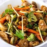 A bowl with chicken stir fry.