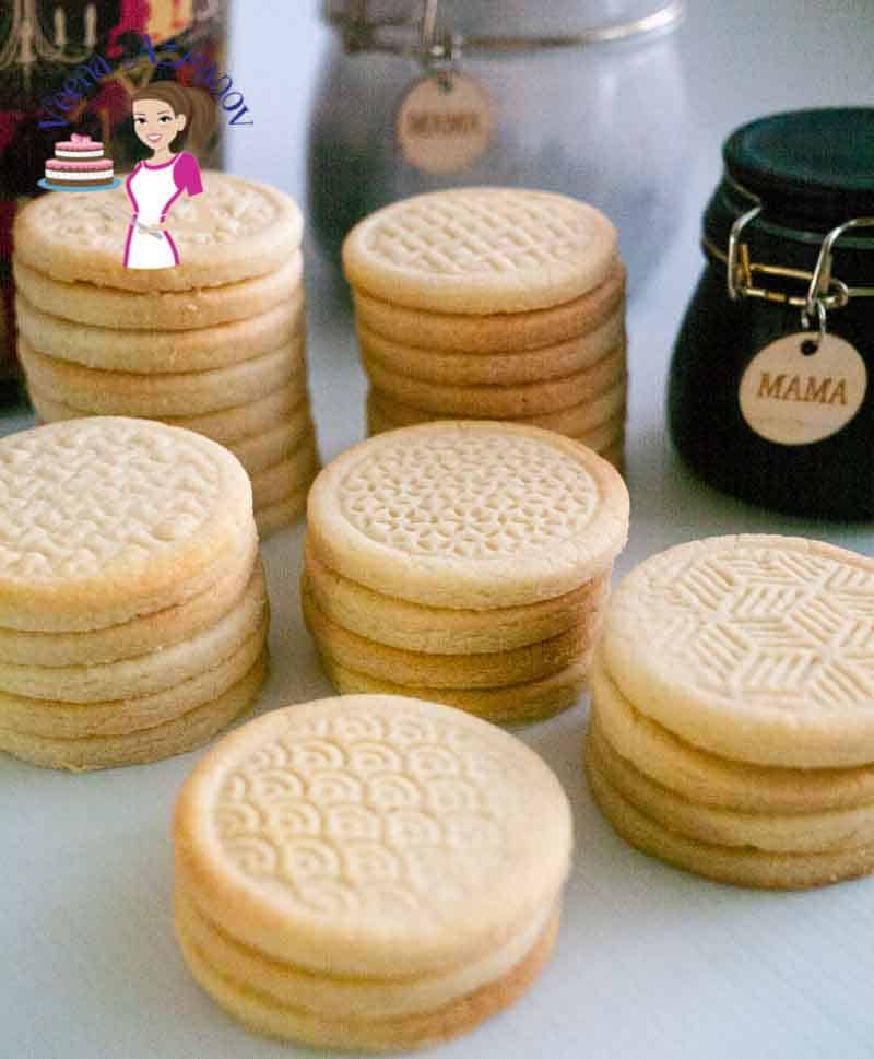 Stacks of stamped shortbread cookies on a table.