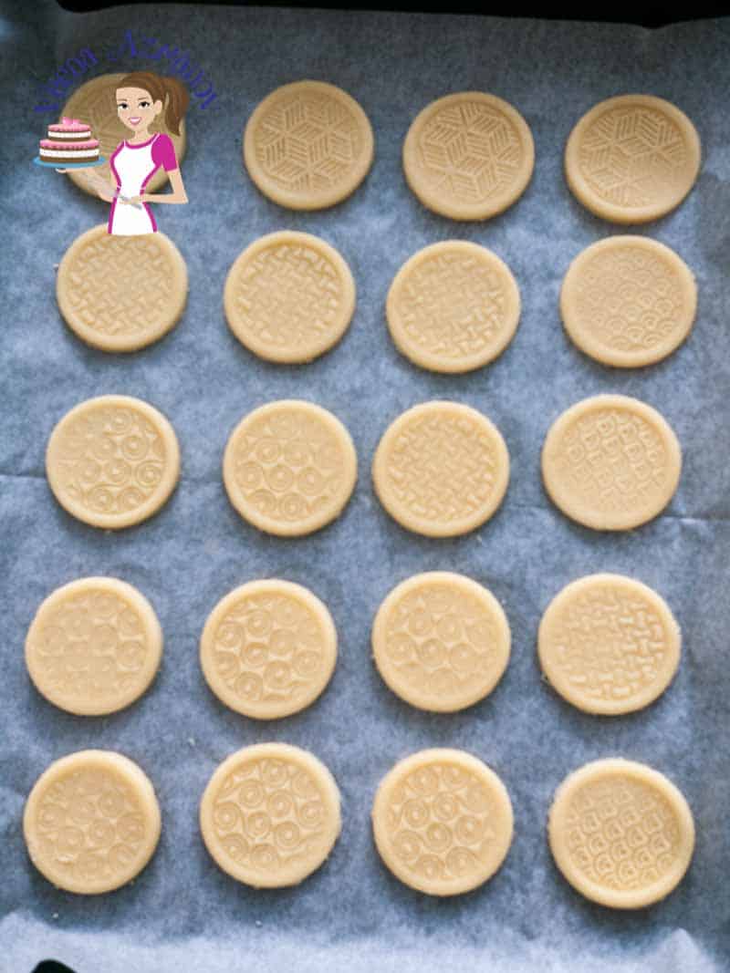 Stamped shortbread cookies on a baking tray.
