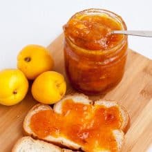 jar with apricot jam and slice with jam.