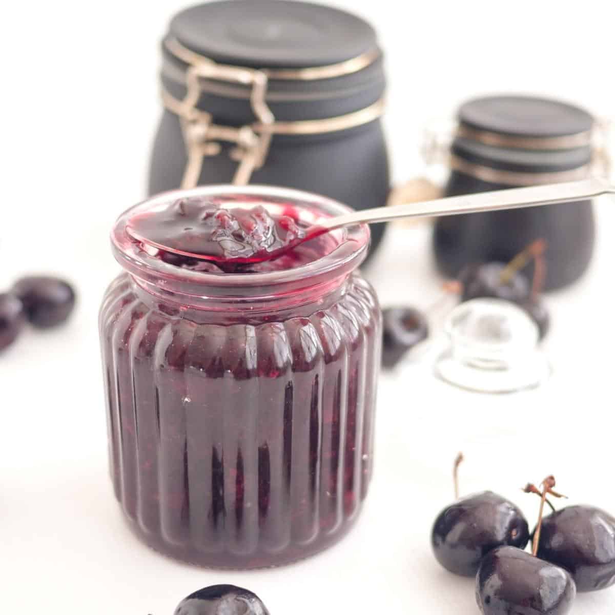 A mason jar with cherry filling.
