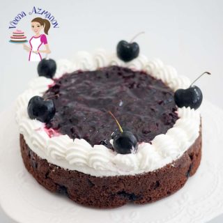 A chocolate cake with cherry topping.
