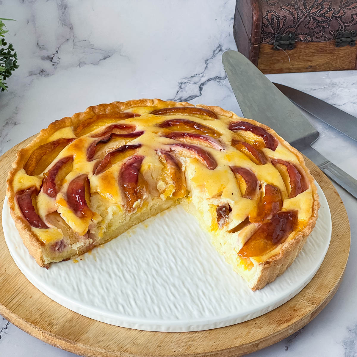 A fresh fruit tart with cream cheese and nectarines.