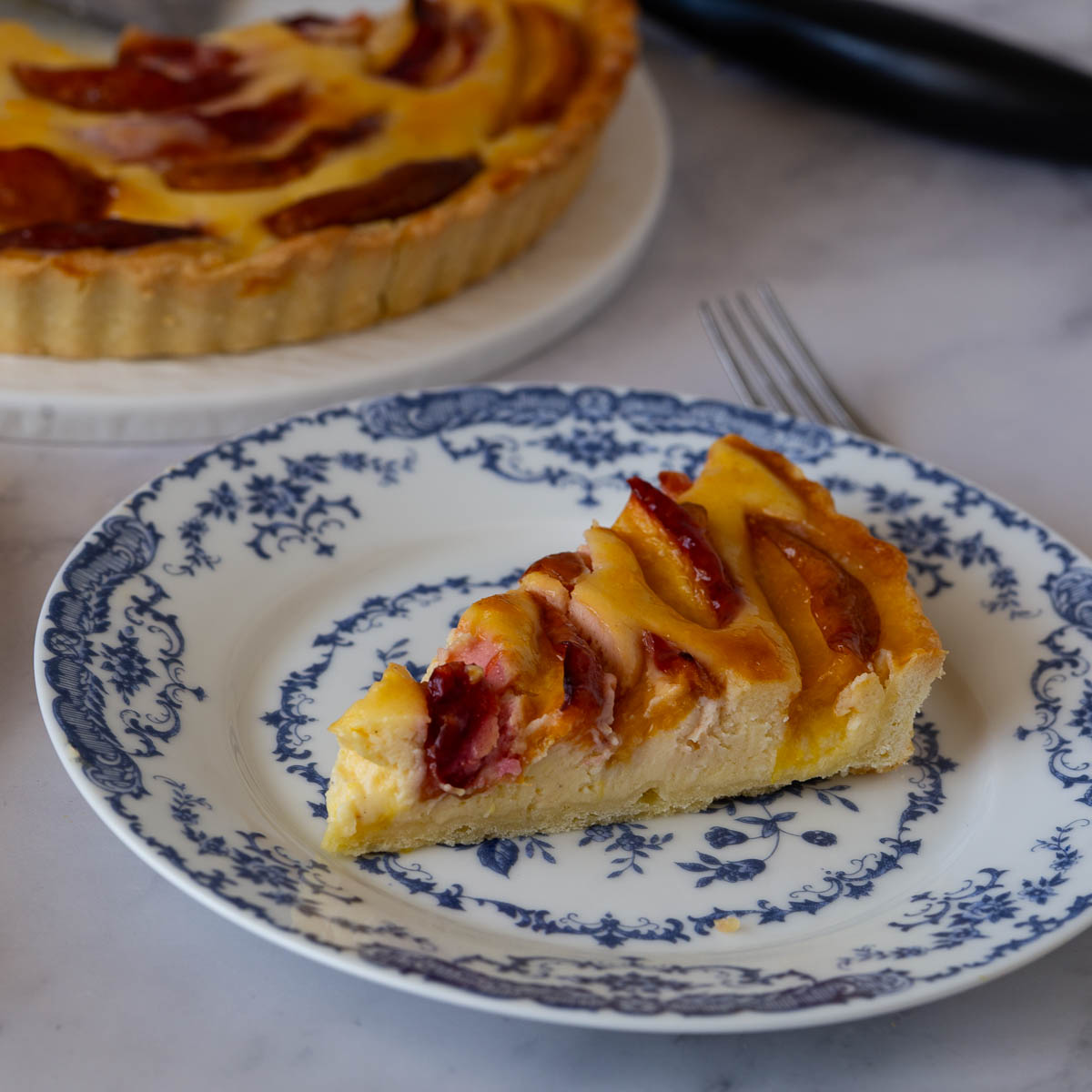 A slice of cream cheese nectarine tart.