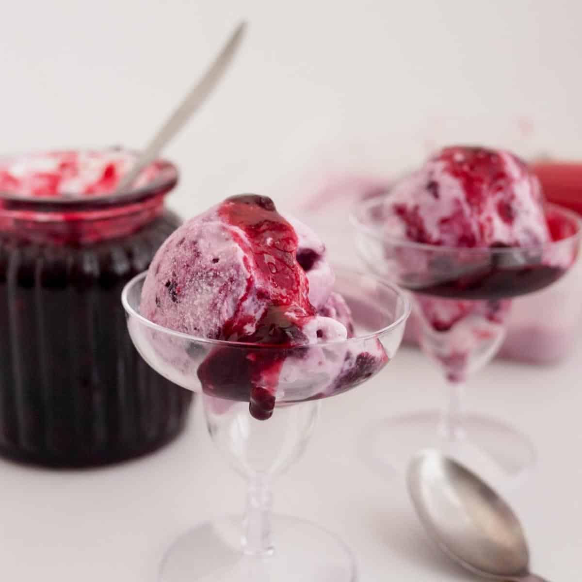 A scoop of cherry ice cream with cherry filling.