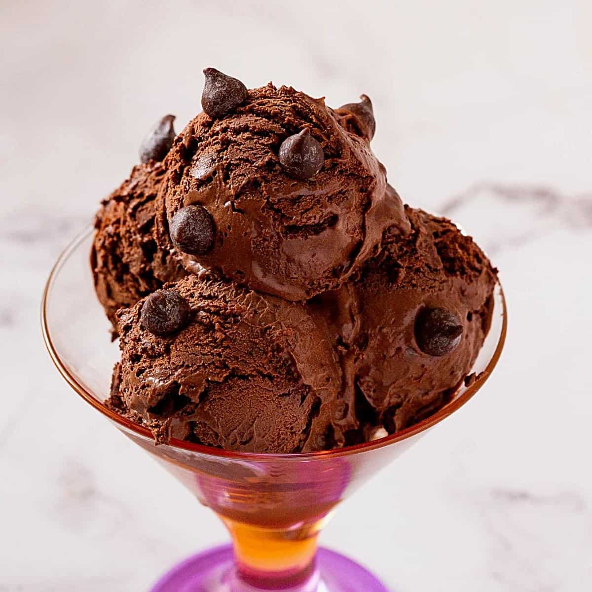 4 scoop of chocolate ice cream in a glass.