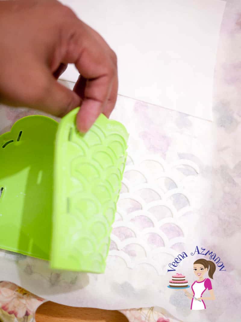 A person making sugar paste designs with silicon mold.