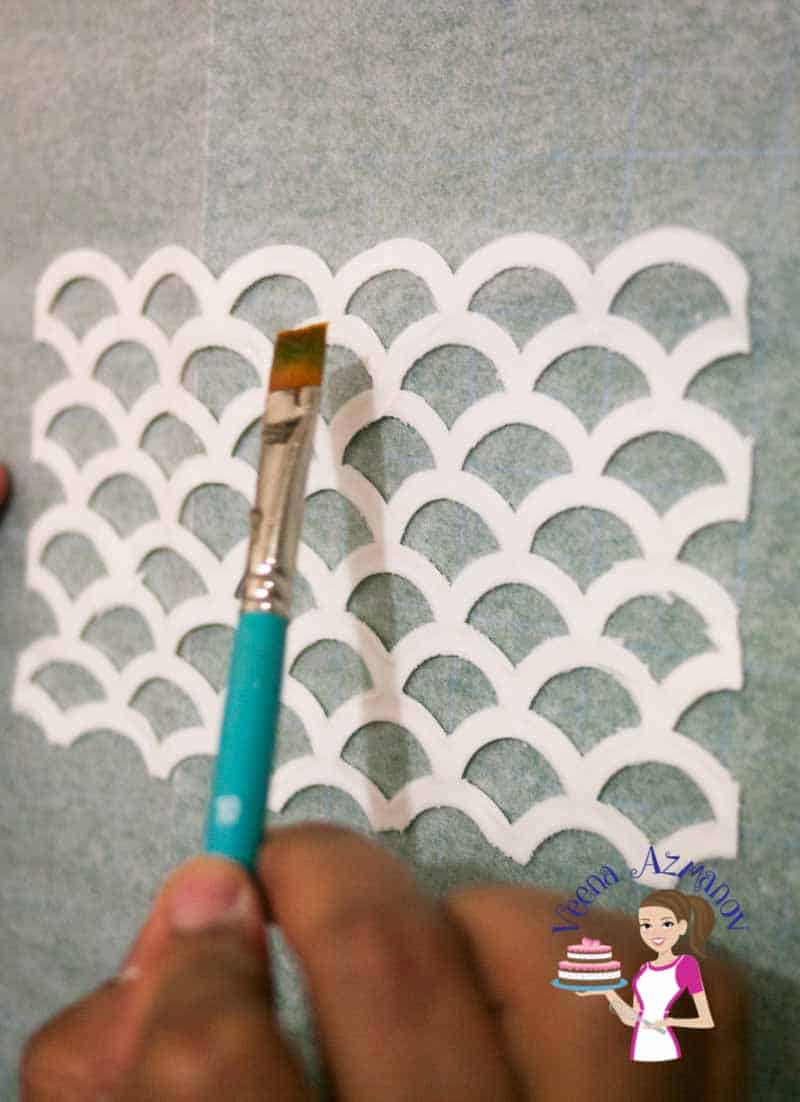A person making sugar paste designs with silicon mold.