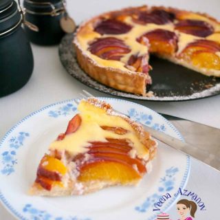 A slice of nectarine tart on a plate.