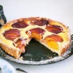 A sliced nectarine tart on a plate.