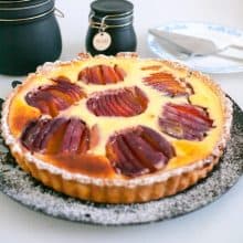 A tart with cream cheese filling and nectarines.