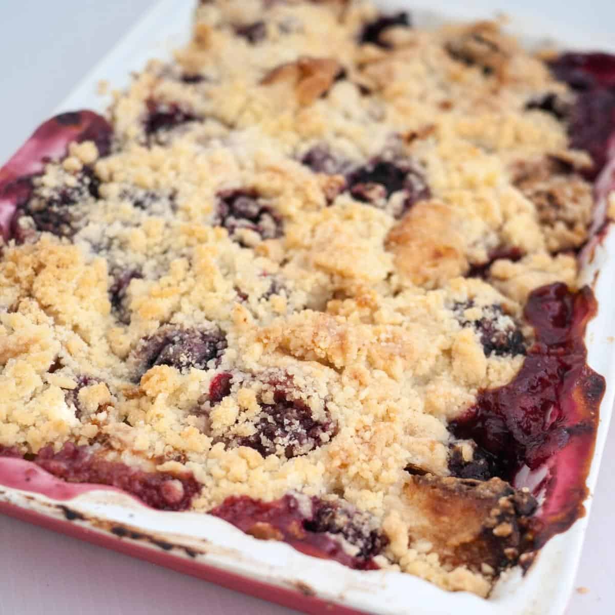 Baking tray with fruit crumble raspberries and peaches.