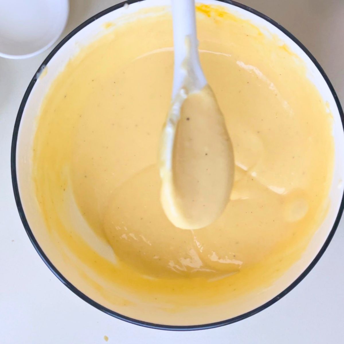 Cream cheese filling in a white bowl.