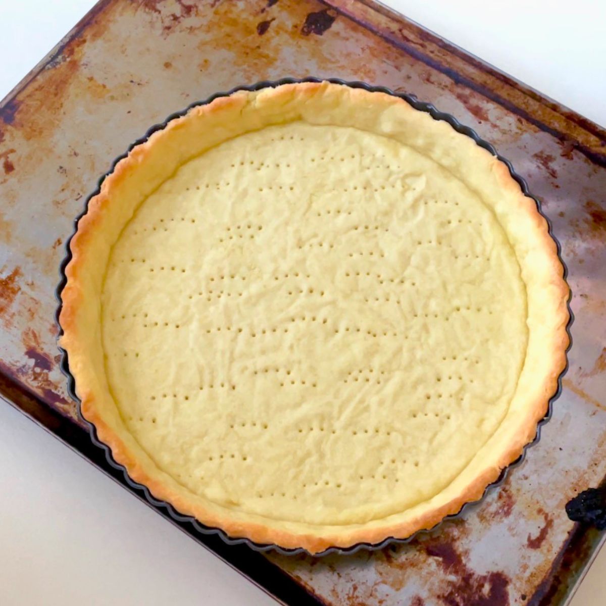 A partially baked shortcrust pastry shell.