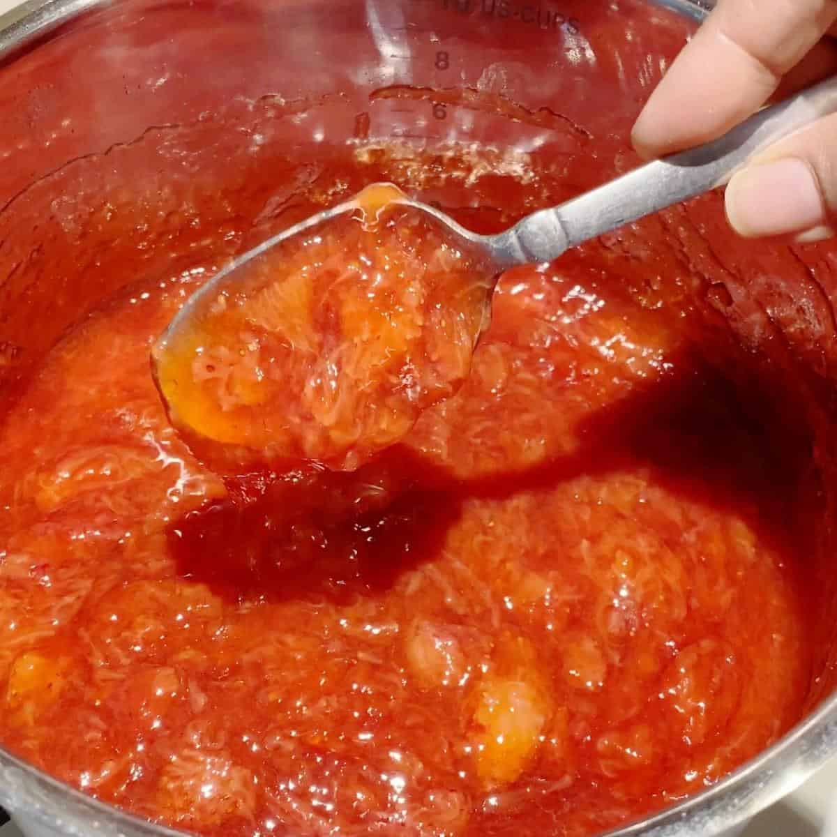 Strawberry filling for cakes cooking in a pot.