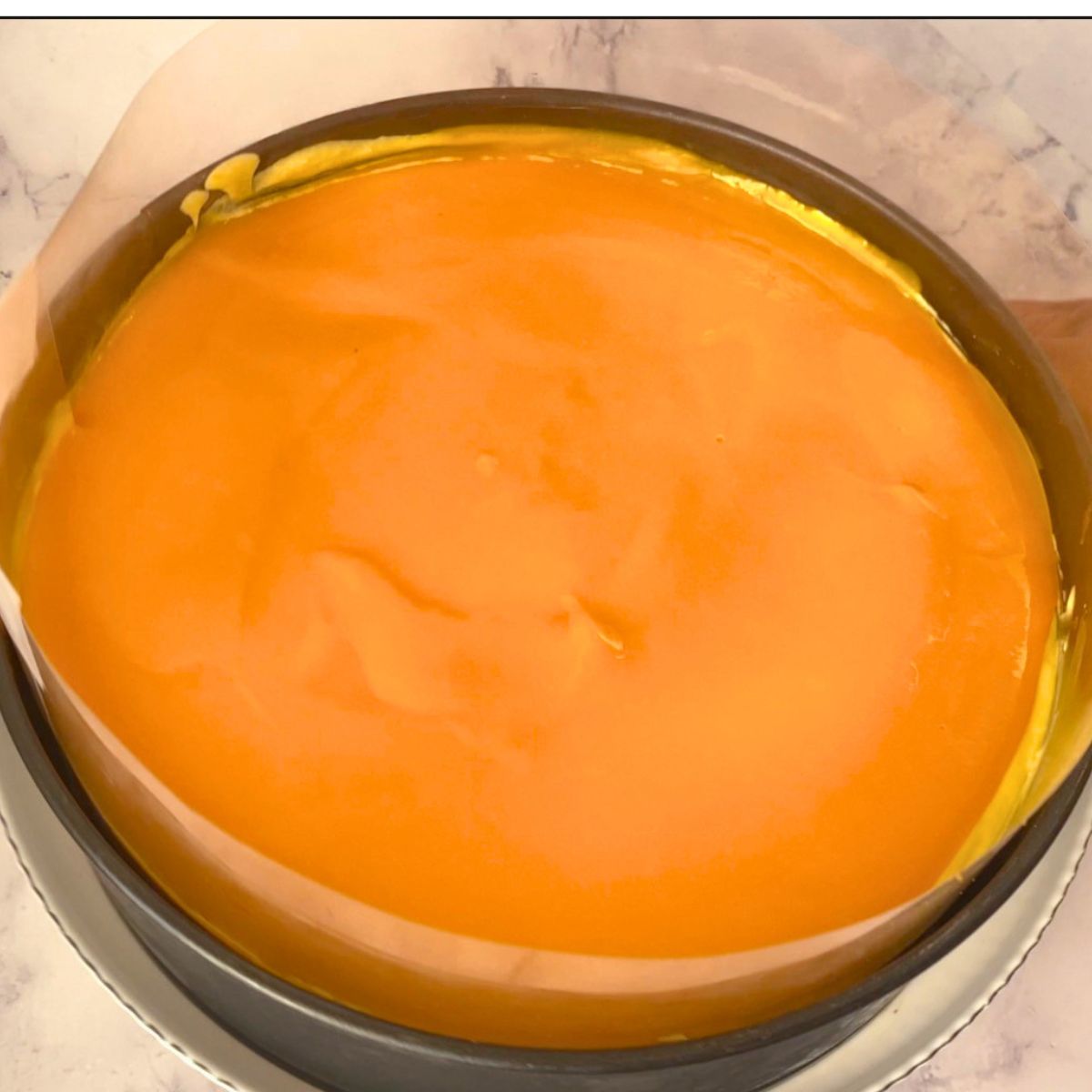 Adding the mango jello over the mango mousse.