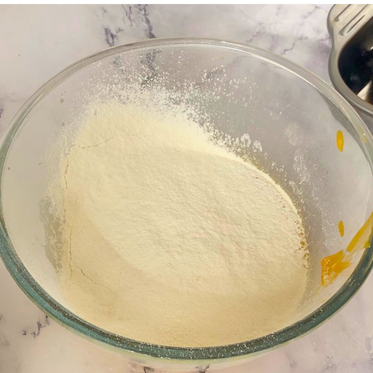Add dry to wet ingredients for the mango cake.