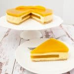 A sliced mango mousse cake.