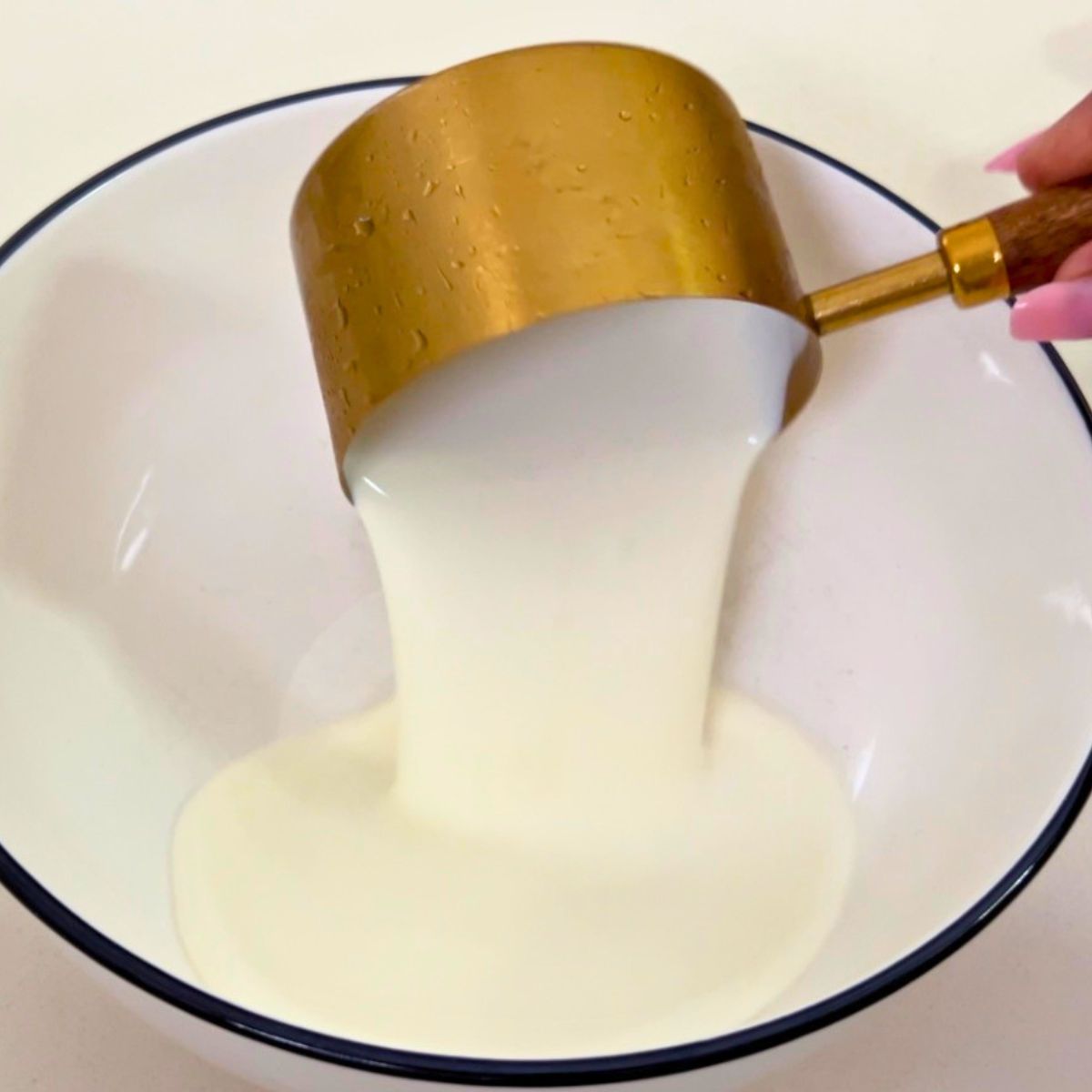 Whipping heavy cream for mango mousse.