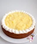 The Eggless Vanilla Cake Recipe is filling with Vanilla pastry cream in the center with a frosting dam