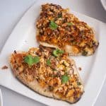A plate with breadcrumb baked fish fillets.