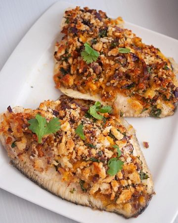 A plate with breadcrumb baked fish fillets.