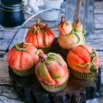 Pumpkin shaped cupcakes on the table.