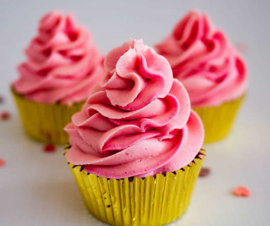 A cupcake with pink buttercream frosting.