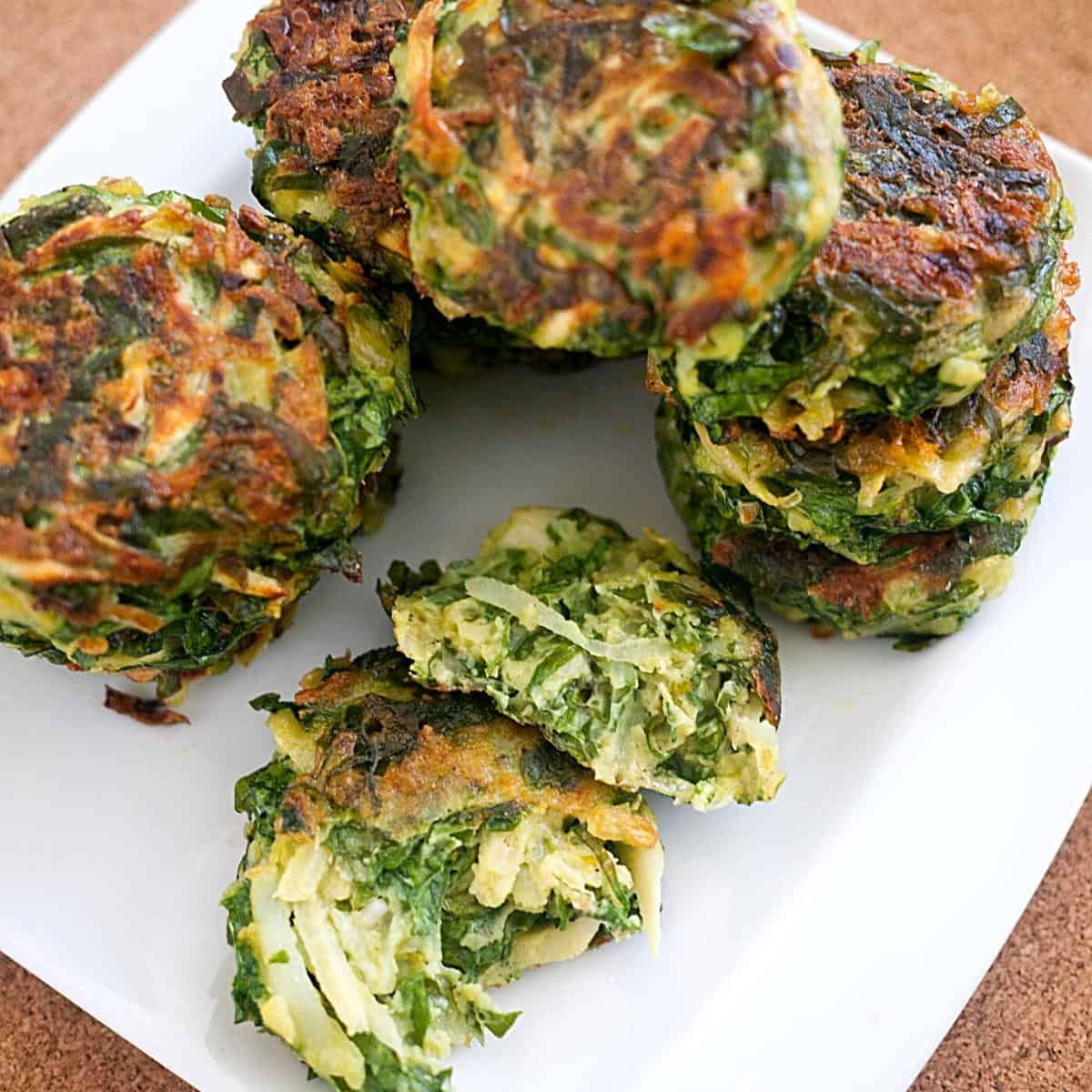 A white plate with vegetable patties.