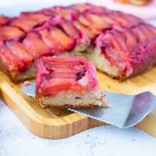 A slice of plum cake on a wooden boards.
