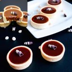 Mini tartlets on a black board.