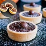 Ganache filled tartlets on a table.