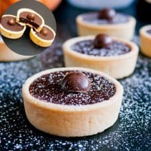 Ganache filled tartlets on a table.