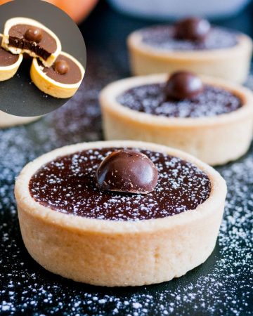Ganache filled tartlets on a table.