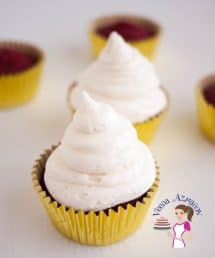 A cupcake with cream cheese frosting.