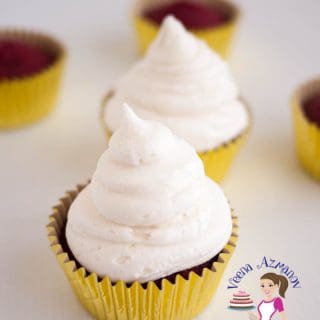 A cupcake with cream cheese frosting.