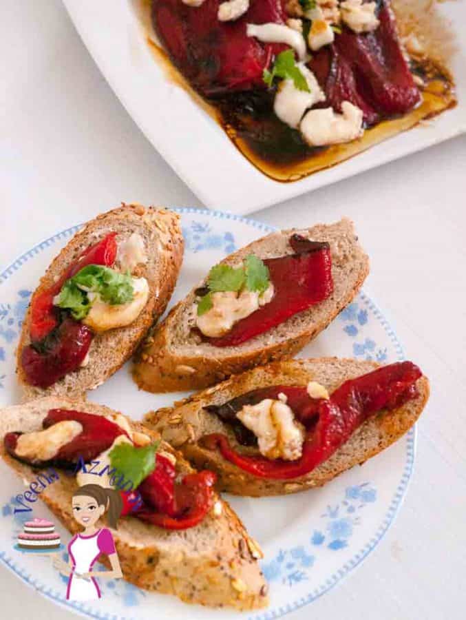 A plate with roasted red pepper and goat cheese crostini.