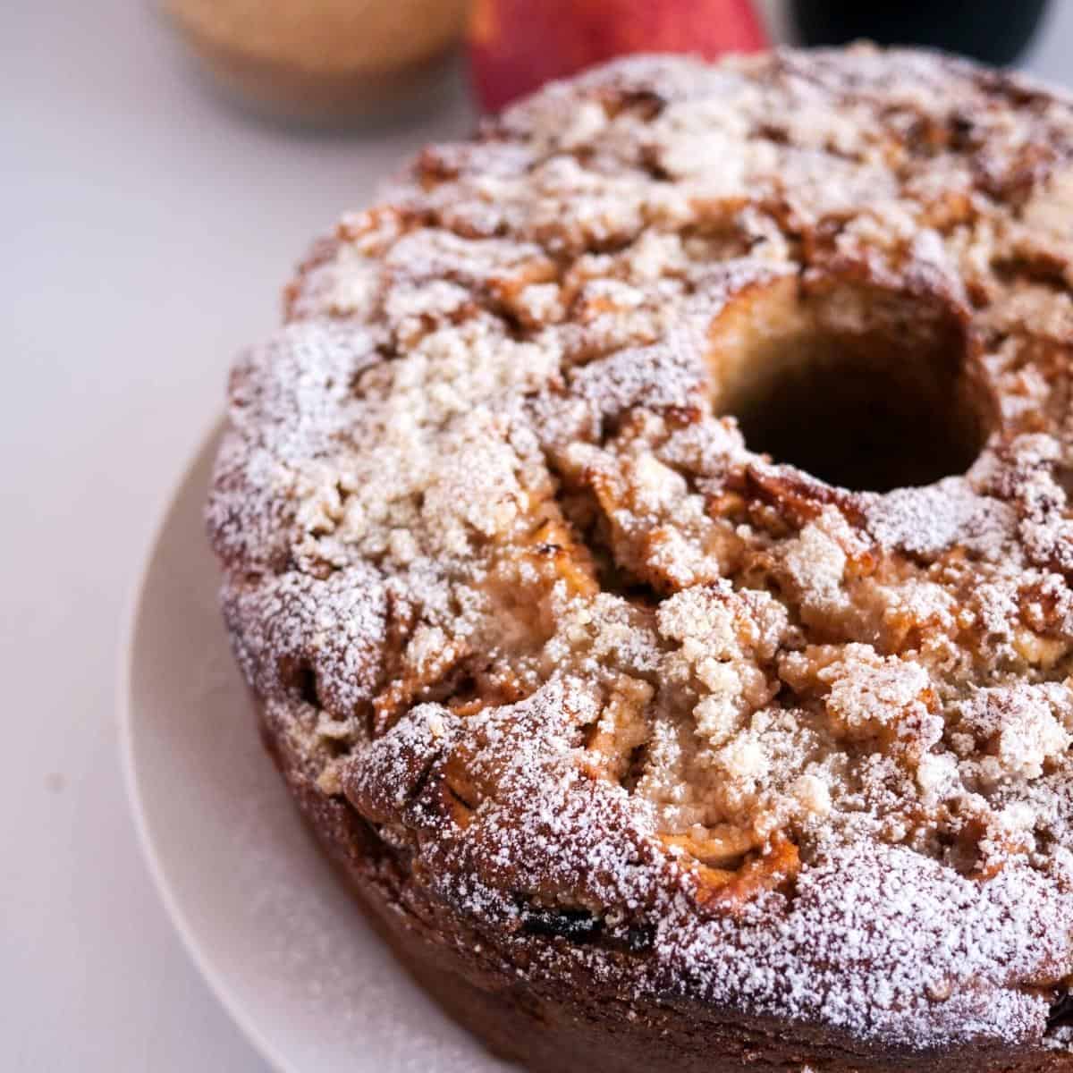 Apple pie cake with crumble on a cake stand.