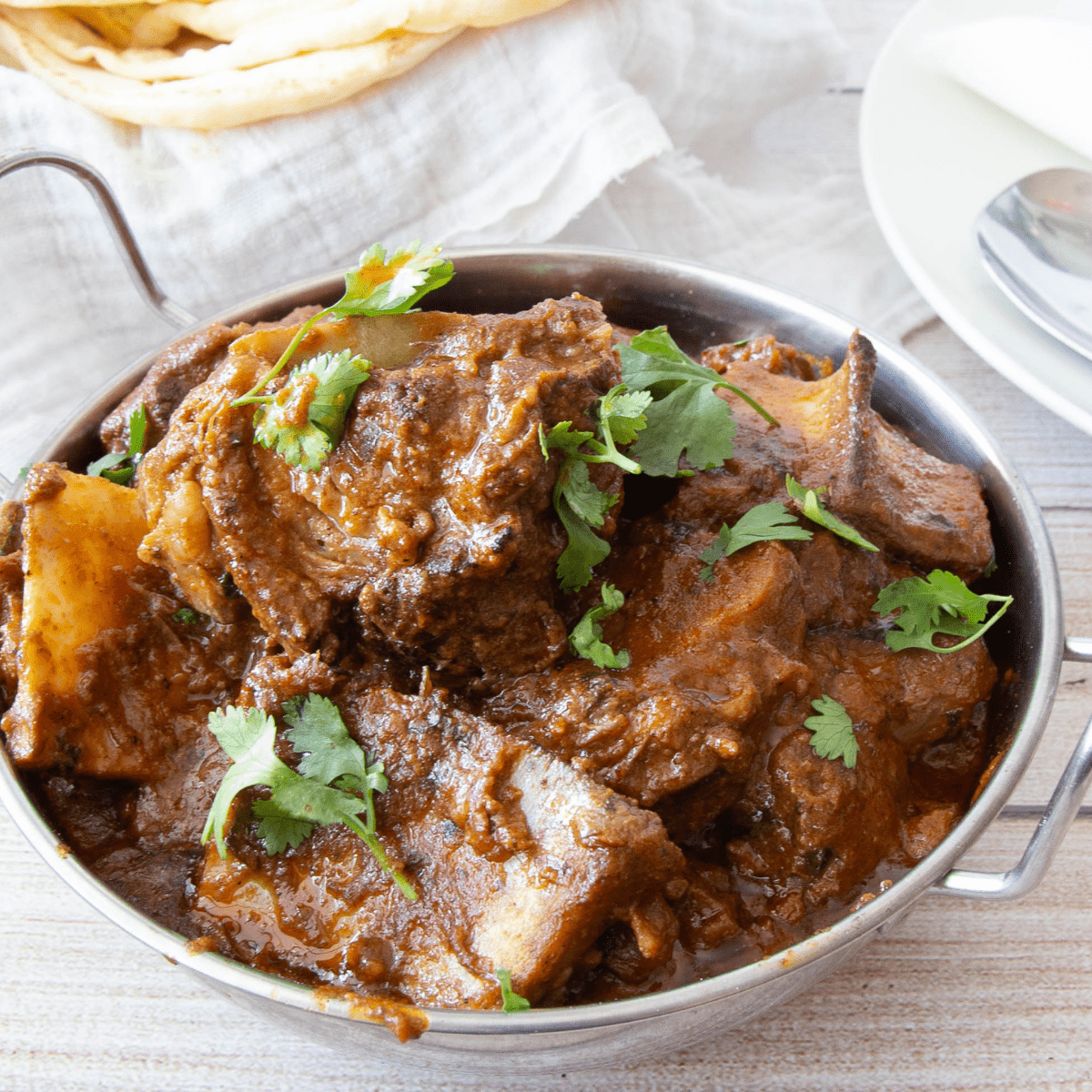 An Indian serving dish with mutton masala.