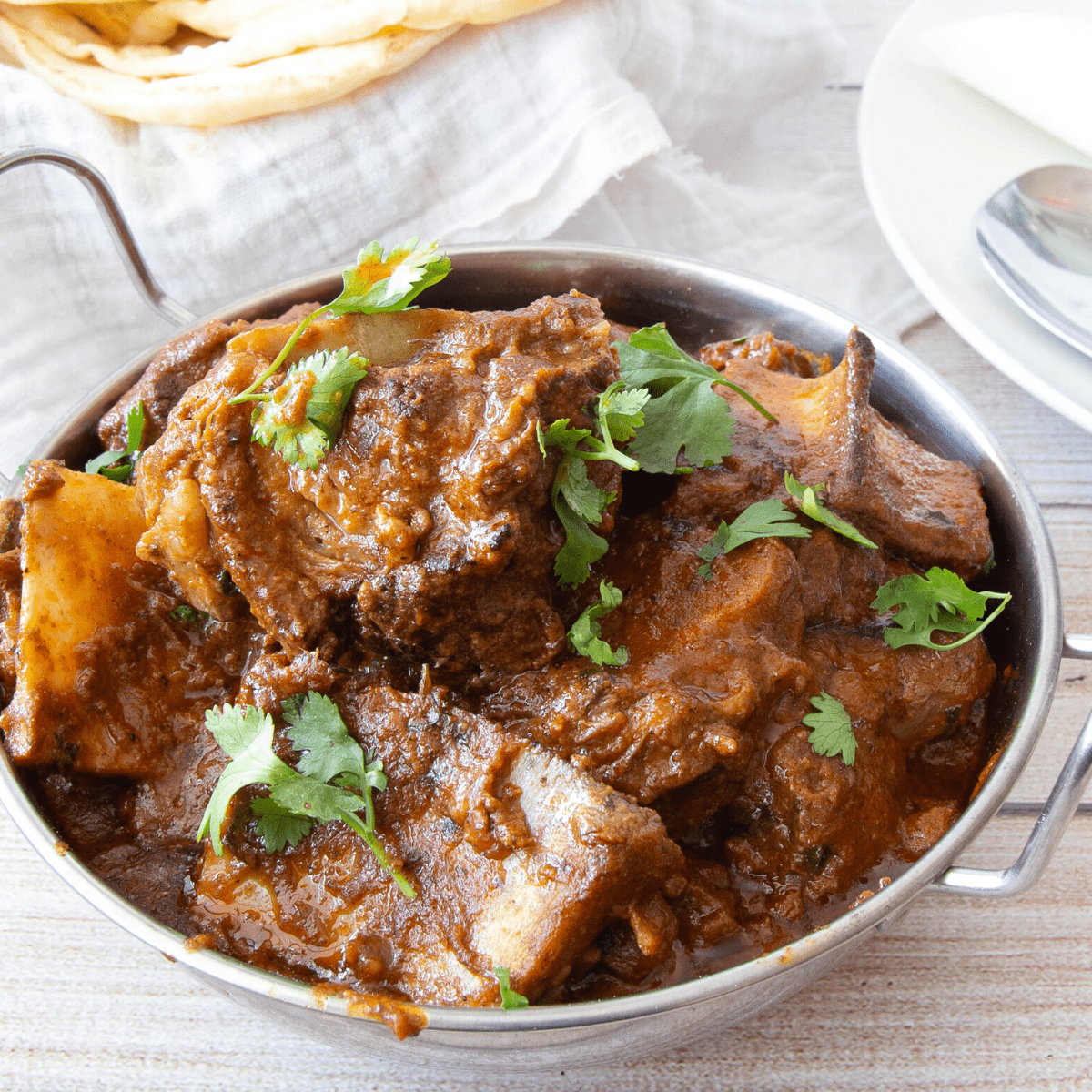 An Indian serving dish with lamb curry masala.