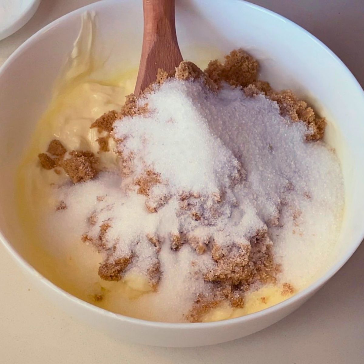 Creaming butter, brown, and white sugar.