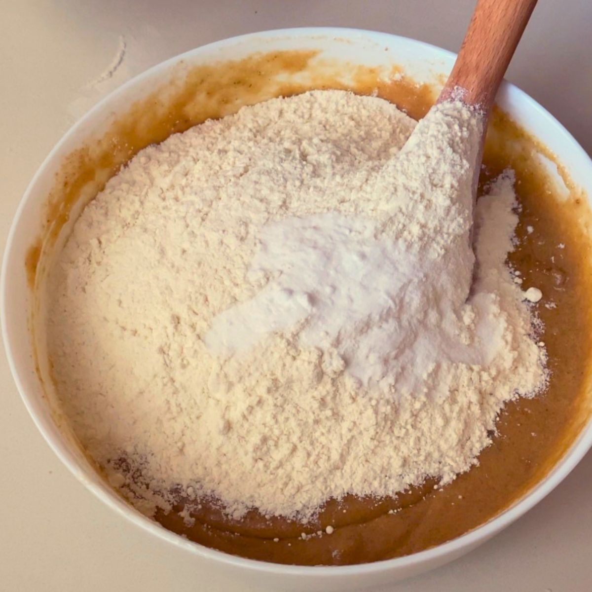 Adding flour to the cookie dough.
