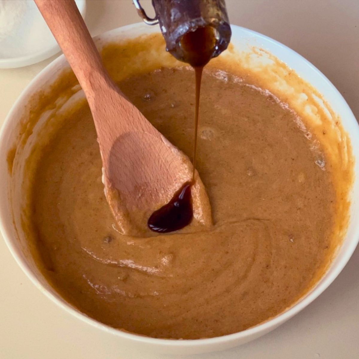 Adding vanilla to the cookie dough.