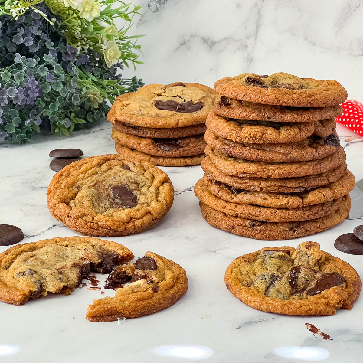 A stack of chocolate chip cookies on the table.