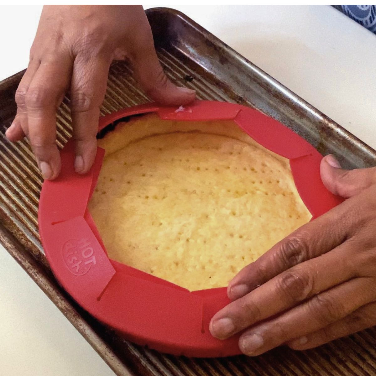 Baking the pastry crust with pie shield.