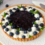 Fresh blueberry tart on the cake stand.
